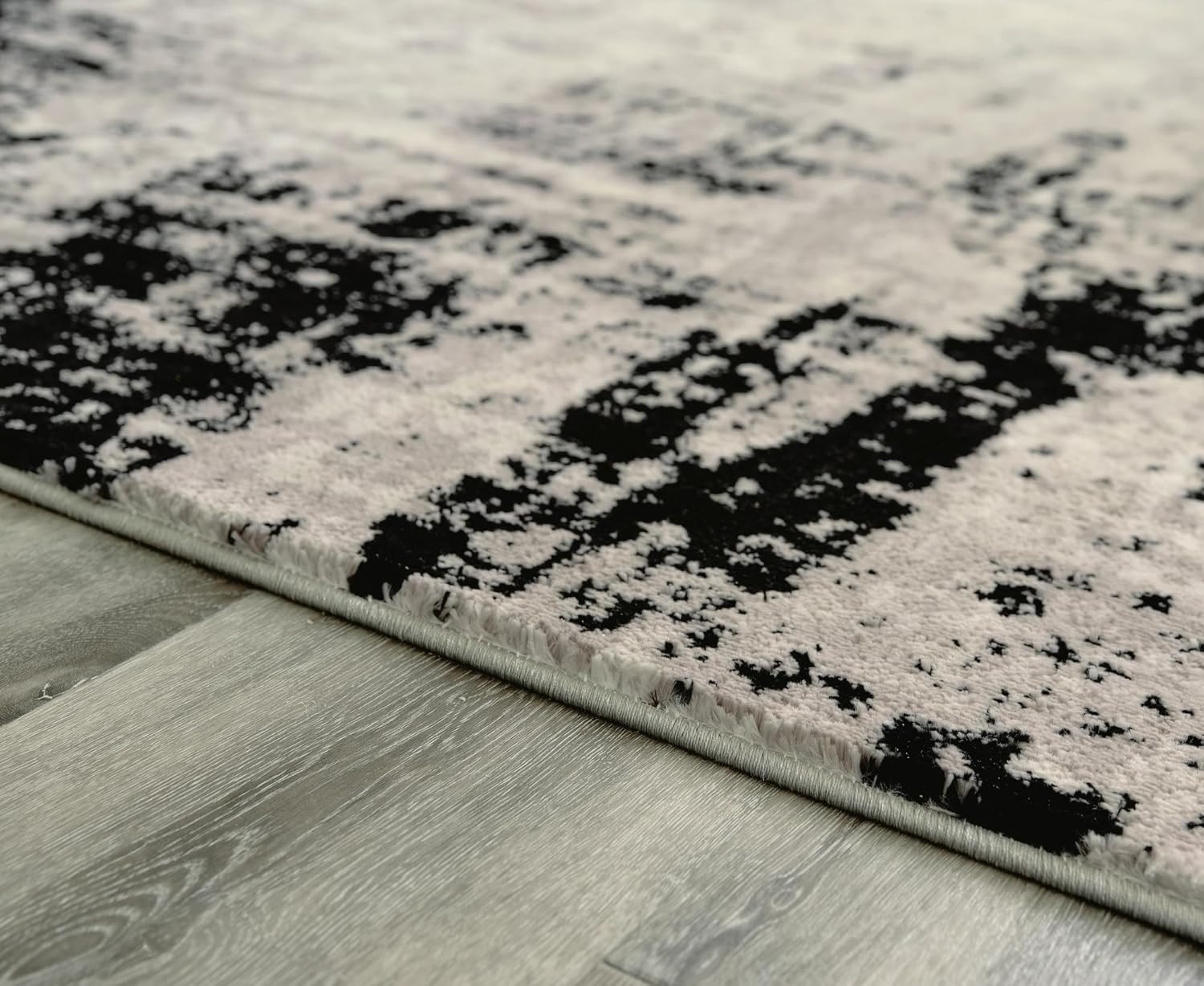 Zekeman 8×10 Abstract Medium Pile Rug in Black, Cream & Gray by Ashley