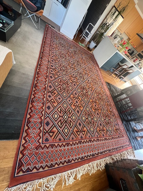 50 years old Algerian wool hand made multi color rug in excellent shape .