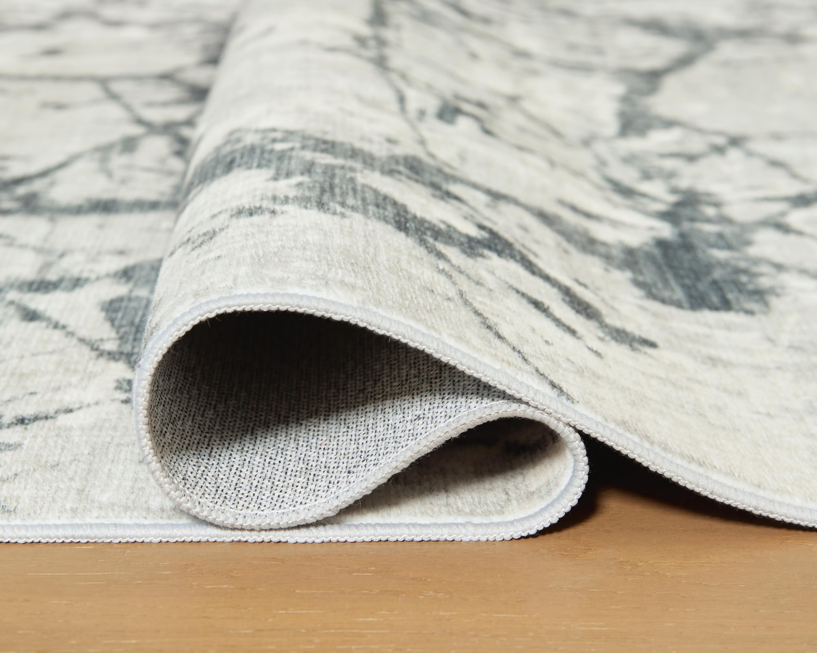 Signature Design by Ashley Tobinbury 8′ x 10′ Washable Area Rug, Gray